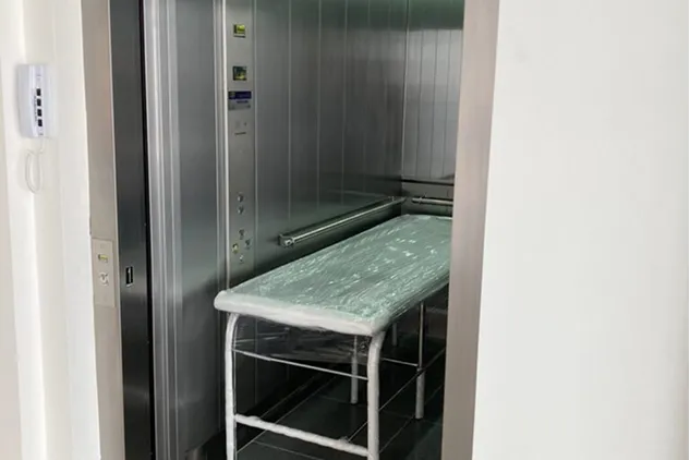 Cabine ampla de elevador maca-leito com maca hospitalar
